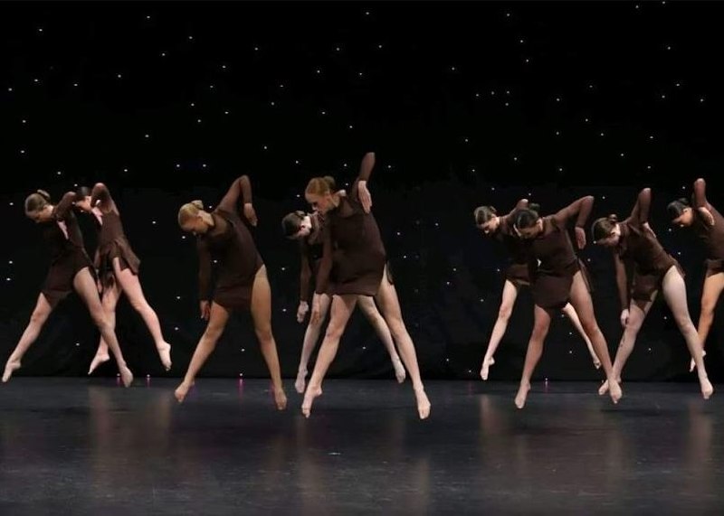 Stage Door Academy dancers performing on stage.