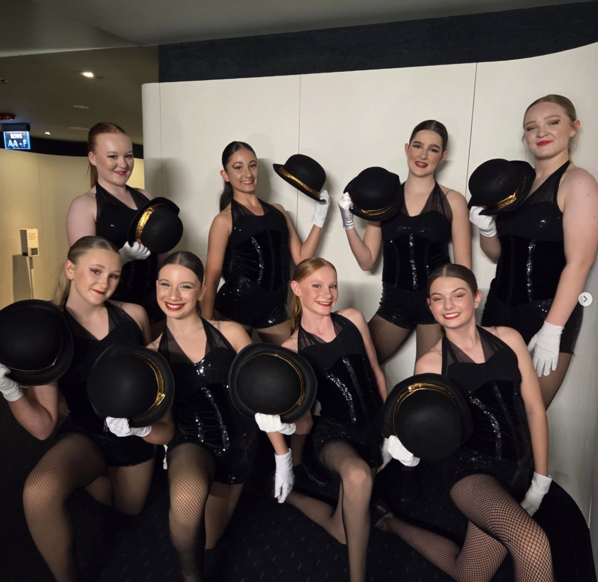 Stage Door Academy jazz students posing with performance hats.