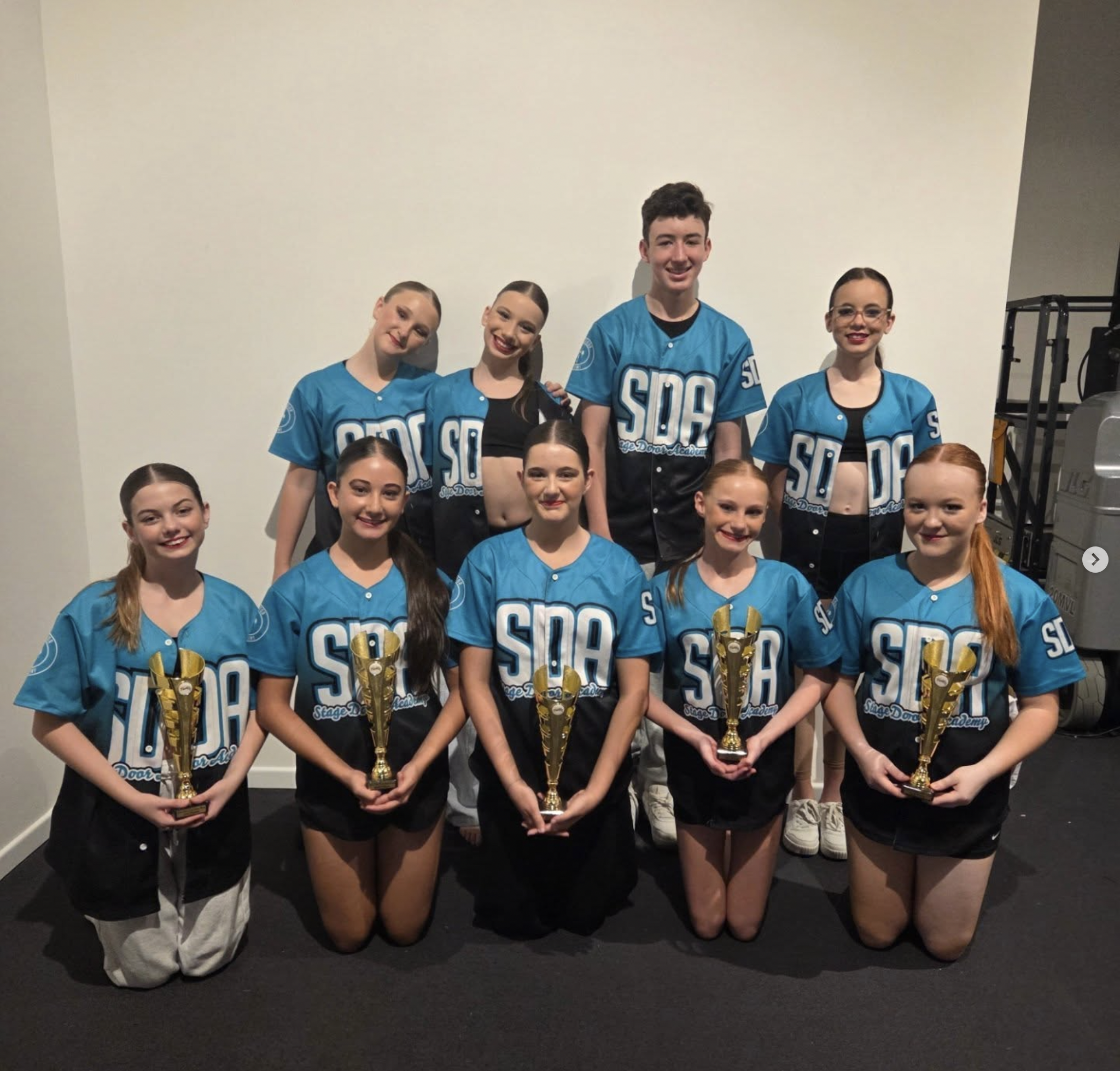 SDA performance team dancers with trophies